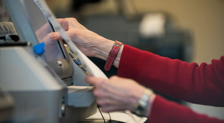 Election official Mary Wickersham enters selections into a voting machine during a public accuracy testing of Election Day voting machines, Oct. 23, 2018 in Minnesota. Election official Mary Wickersham enters selections into a voting machine during a public accuracy testing of Election Day voting machines, Oct. 23, 2018 in Minnesota.
