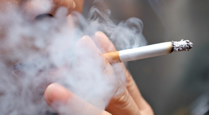 A person smoking a cigarette. A person smoking a cigarette.