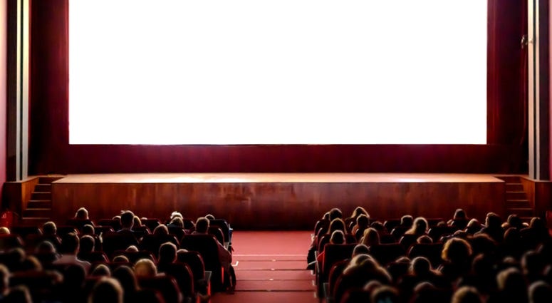 People watching a movie in a theatre. People watching a movie in a theatre.