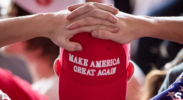 A man wears a 'Make America Great Again' hat as he waits for U.S. President Donald Trump to arrive for a 'Make America Great Again' campaign rally at Williamsport Regional Airport, May 20, 2019 in Montoursville, Pennsylvania. MAGA hat