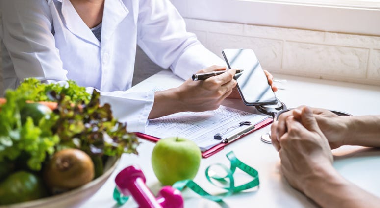 A person talking to a doctor about a diet. A person talking to a doctor about a diet.