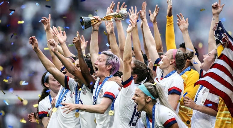LYON, FRANCE - JULY 07: (EDITORS NOTE: Image has been digitally enhanced.) Megan Rapinoe of the USA lifts the FIFA Women's World Cup Trophy following her team's victory in the 2019 FIFA Women's World Cup France Final match. Megan Rapinoe of the USA lifts the FIFA Women's World Cup Trophy following her team's victory in the 2019 FIFA Women's World Cup France Final match between The United States of America and The Netherlands at Stade de Lyon on July 07, 2019 in Lyon, France.