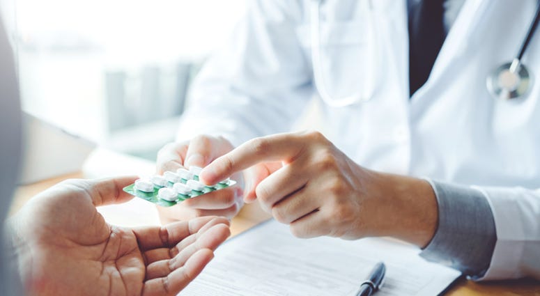 A doctor giving a patient medicine. A doctor giving a patient medicine.