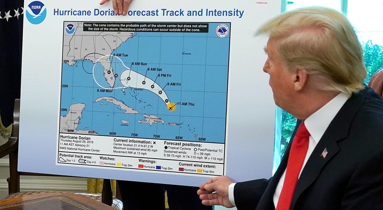 President Donald Trump references a map about Hurricane Dorian in the Oval Office, Sept. 4, 2019. The map was a forecast from Aug. 29 and appears to have been altered by a black marker to extend the hurricane's range to include Alabama. Trump displays Hurricane Dorian map