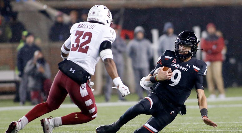 Desmond Ridder #9 of the Cincinnati Bearcats avoids a tackle from Benny Walls #32 of the Temple Owls during the second quarter at Nippert Stadium on November 23, 2019 in Cincinnati, Ohio. Desmond Ridder #9 of the Cincinnati Bearcats avoids a tackle from Benny Walls #32 of the Temple Owls during the second quarter at Nippert Stadium on November 23, 2019 in Cincinnati, Ohio.