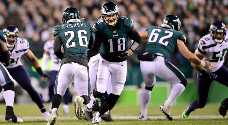 Quarterback Josh McCown #18 of the Philadelphia Eagles hands off the ball to Miles Sanders #26 during the NFC Wild Card Playoff game against the Seattle Seahawks at Lincoln Financial Field on Jan. 5, 2020 in Philadelphia, Pennsylvania. Eagles