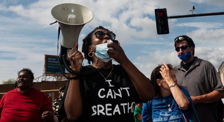 MINNEAPOLIS, MN - MAY 26: Protesters call for justice for George Floyd following his death on Monday outside the Cup Foods on May 26, 2020 in Minneapolis, Minnesota. Protesters call for justice for George Floyd following his death on Monday outside the Cup Foods on May 26, 2020 in Minneapolis, Minnesota.