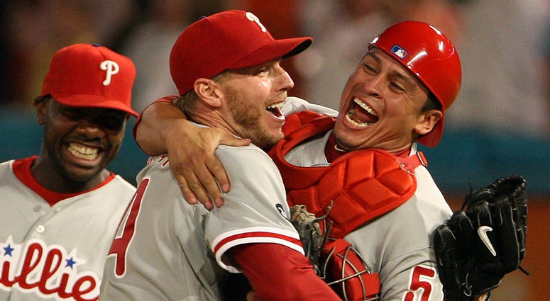 Philadelphia Phillies pitcher Roy Halladay, center, is greeted by catcher Carlos Ruiz, following Halladay's perfect game shut out against the Florida Marlins. The Phillies defeated the Marlins, 1-0, at Sun Life Stadium in Miami, Florida, May 29, 2010. Roy Halladay’s perfect game