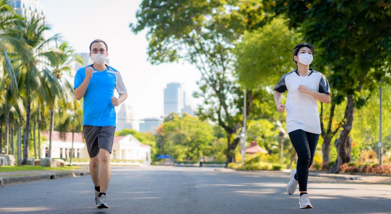 Two people jogging outside Two people jogging outside