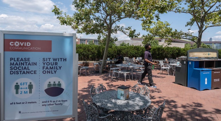 NEW YORK, NY - JULY 20: A man wearing a protective mask walks in the cafeteria as it reopened on Liberty Island on July 20, 2020 A man wearing a protective mask walks in the cafeteria as it reopened on Liberty Island on July 20, 2020