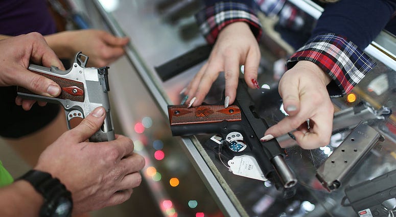 POMPANO BEACH, FL - DECEMBER 23: A customer compares handguns before buying one as a Christmas present at the National Armory gun store on December 23, 2015 in Pompano Beach, Florida. POMPANO BEACH, FL - DECEMBER 23: A customer compares handguns before buying one as a Christmas present at the National Armory gun store on December 23, 2015 in Pompano Beach, Florida.