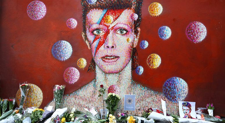 Flowers are laid beneath a mural of David Bowie in Brixton on January 11, 2016 in London, England. Flowers are laid beneath a mural of David Bowie in Brixton on January 11, 2016 in London, England.