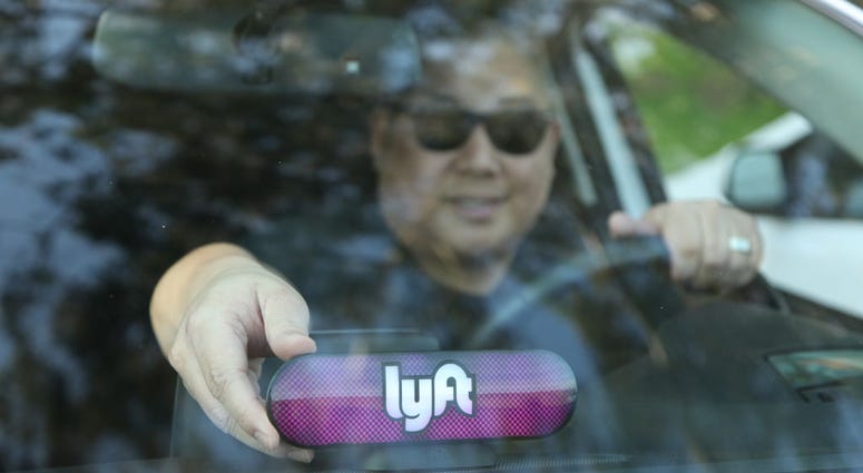 A Lyft driver places the Amp on his dashboard on Jan. 31, 2017 in San Francisco, California. A Lyft driver places the Amp on his dashboard.