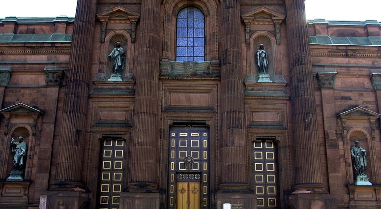 Tourists walk past the Cathedral Basilica of Saints Peter and Paul March 22, 2002 in Philadelphia. Cathedral Basilica of Saints Peter and Paul