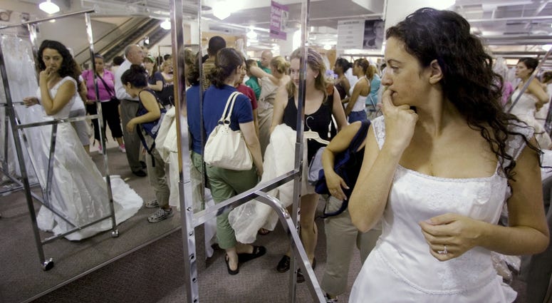 Bride-to-be Jennie Rothenberg tries on a wedding gown during Filene's Basement's annual sale, Aug. 4, 2006 in Washington, D.C. Bride-to-be Jennie Rothenberg tries on a wedding gown during Filene's Basement's annual sale, Aug. 4, 2006 in Washington, D.C.