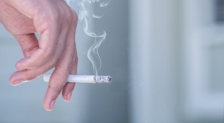 man smoking a cigarette - stock photo man smoking a cigarette - stock photo