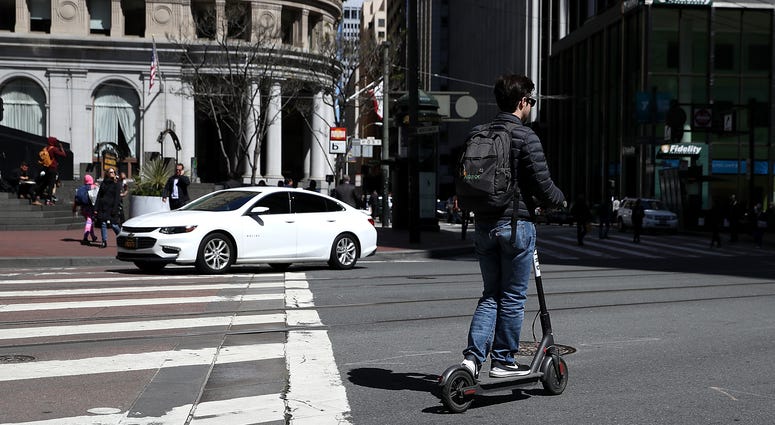 A user rides a Bird scooter on April 17, 2018 in San Francisco, California. E-scooter