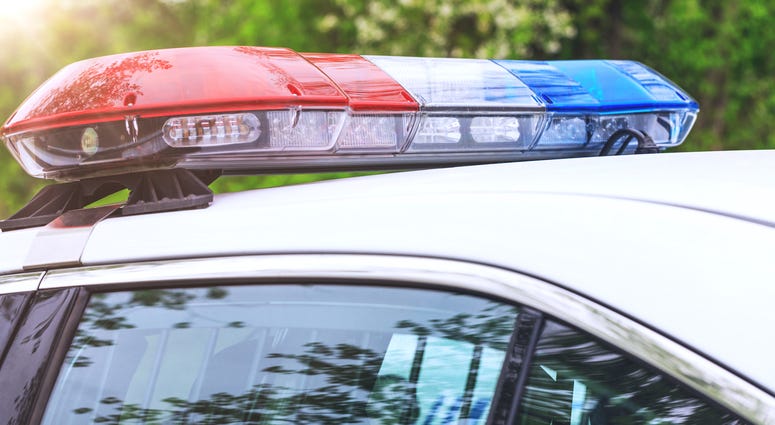 Police patrol car with sirens off during a traffic control. Blue and red flashing sirens of police car during the roadblock in the city. Police Light Generic