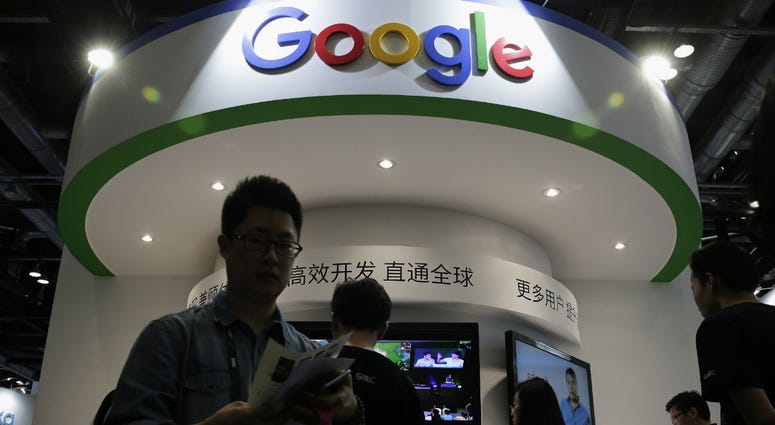 In this April 28, 2016, file photo, visitors gather at a display booth for Google at the 2016 Global Mobile Internet Conference (GMIC) in Beijing. In this April 28, 2016, file photo, visitors gather at a display booth for Google at the 2016 Global Mobile Internet Conference (GMIC) in Beijing.
