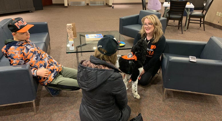 17-year-old Jack Stockmal (left) and his mother Carrie (middle), with neuropsychologist Jennifer West-Gavin and service companion dog Lullaby (right). 17-year-old Jack Stockmal (left) and his mother Carrie (middle), with neuropsychologist Jennifer West-Gavin and service companion dog Lullaby (right).