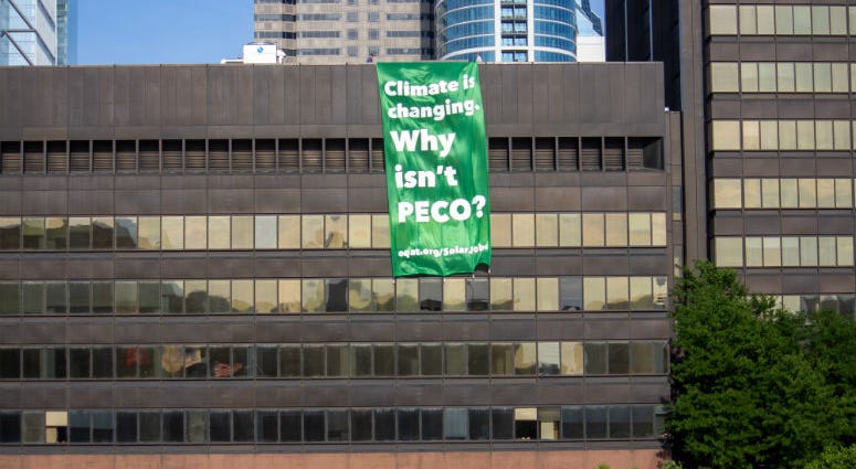 On a broiling mid-July afternoon, three activists from EQAT (pronounced "equate") were arrested for unfurling a banner from the roof of PECO's headquarters on Market Street declaring, "Climate is changing — Why isn't PECO?" On a broiling mid-July afternoon, three activists from EQAT (pronounced "equate") were arrested for unfurling a banner from the roof of PECO's headquarters on Market Street declaring, "Climate is changing — Why isn't PECO?"