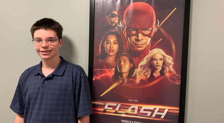 Michael stands next to a promotional poster for his favorite TV show, "The Flash," at the KYW broadcast center. Michael stands next to a promotional poster for his favorite TV show, "The Flash," at the KYW broadcast center.