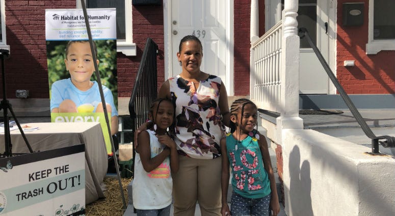 Veteran Tamara Charles in front of her brand new Habitat for Humanity home. Tamara Charles