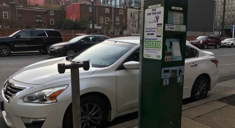 A Center City parking kiosk next to the remains of an old meter stand. A Center City parking kiosk next to the remains of an old meter stand.