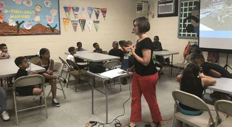 Julie Bush, principal at Ground Reconsidered, getting input on the Heitzman Recreation Center from kids. Philadelphia's tiniest residents get a chance to give their input on the redevelopment of a neighborhood park, and the job is no small task.