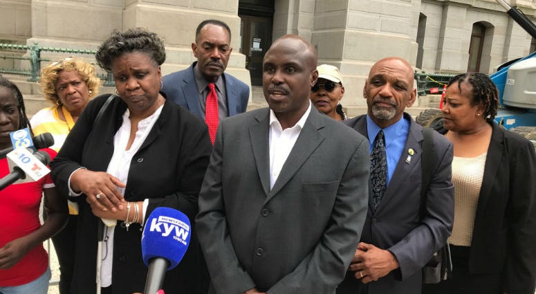 Rally for Justice Coalition claims more officers will be fired over racist posts. Rally for Justice Coalition talking to reporters.