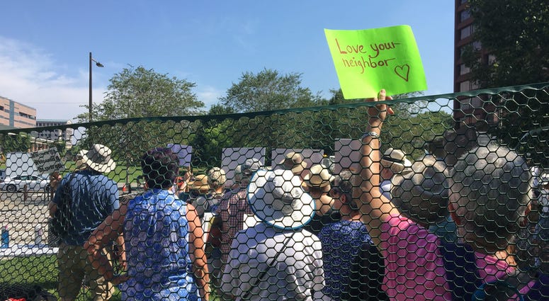 Dozens of seniors packed themselves into a small, makeshift enclosure today, and stood outside in the dangerous heat and humidity to protest migrant family separation and child detention. Dozens of seniors packed themselves into a small, makeshift enclosure today, and stood outside in the dangerous heat and humidity to protest migrant family separation and child detention.