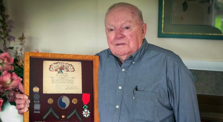 Kenneth Happel displays his honors from World War II. Kenneth Happel's honors