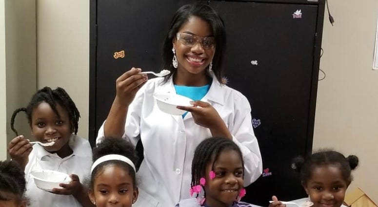 Jacqueline Means doing experiments with kids. Jacqueline Means doing experiments with kids.