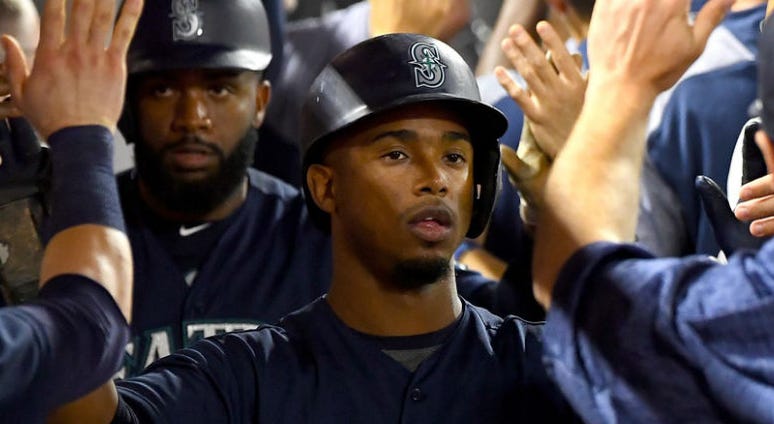 Seattle Mariners left fielder Denard Span (4) and shortstop Jean Segura (2)are greeted in the dugout Seattle Mariners left fielder Denard Span (4) and shortstop Jean Segura (2)are greeted in the dugout
