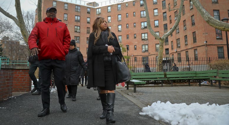 In this March 6, 2019 photo, Lynne Patton, right, HUD executive, and Robert Madison, left, associate director of community organization Jacob Riis Settlement, tour Queensbridge Houses residencies in New York In this March 6, 2019 photo, Lynne Patton, right, HUD executive, and Robert Madison, left, associate director of community organization Jacob Riis Settlement, tour Queensbridge Houses residencies in New York