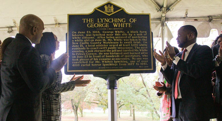 The Shepherd family and members of the Delaware Legislative Black Caucus applaud after the Oct. 20, 2019 unveiling of a new historical marker memorializing the 1903 lynching of laborer George White. Historical marker of George White unveiled