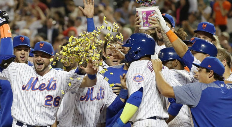 New York Mets' Brandon Nimmo (9) runs toward home plate and waiting teammates on a walk-off three-run home run during the 10th inning of a baseball game against the Philadelphia Phillies on Wednesday, July 11, 2018, in New York. New York Mets' Brandon Nimmo (9) runs toward home plate and waiting teammates on a walk-off three-run home run during the 10th inning of a baseball game against the Philadelphia Phillies on Wednesday, July 11, 2018, in New York.