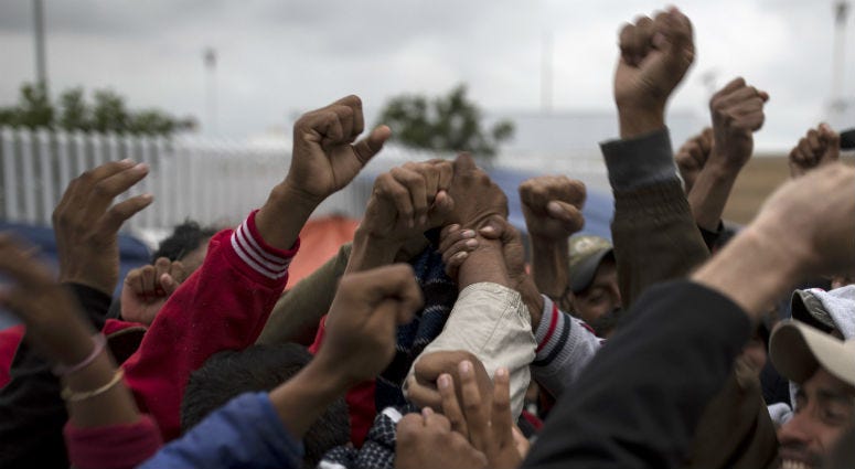 Migrants cheer and celebrate after hearing the news U.S. border inspectors allowed some of the Central American asylum-seekers to enter the country for processing, in Tijuana, Mexico, Monday, April 30, 2018, ending a brief impasse over lack of space. Migrants cheer and celebrate