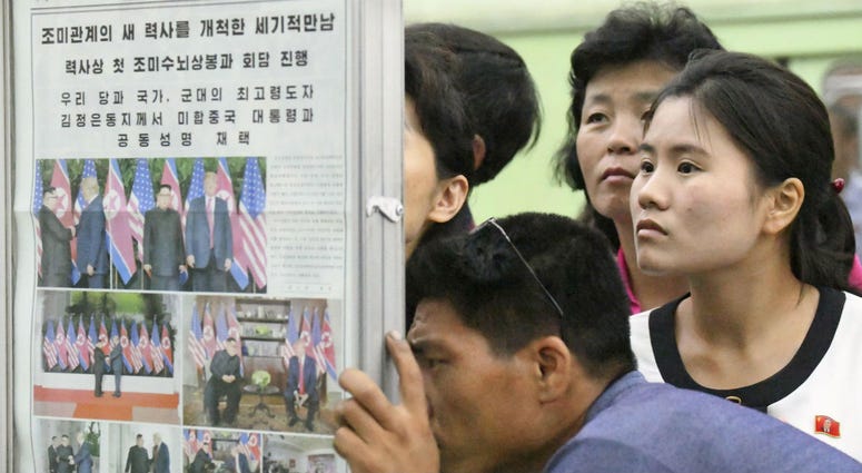 People look at the display of local newspaper reporting the meeting between North Korean leader Kim Jong Un and U.S. President Donald Trump, at a subway station in Pyongyang, North Korea Wednesday, June 13, 2018. People look at the display of local newspaper reporting the meeting between North Korean leader Kim Jong Un and U.S. President Donald Trump, at a subway station in Pyongyang, North Korea Wednesday, June 13, 2018.