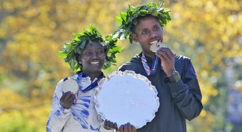 First place finishers Mary Keitany of Kenya, left, and Lelisa Desisa of Ethiopia pose for a picture at the finish line of the New York City Marathon in New York, Sunday, Nov. 4, 2018.