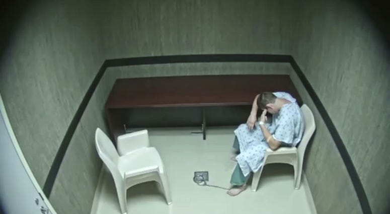 In this image made from video provided on Wednesday, Aug. 8, 2018, by the Broward County Sheriff's Office, Nikolas Cruz points his fingers to his temple at an interrogation room, while officers are out of the room, in Fort Lauderdale, Fla. In this image made from video provided on Wednesday, Aug. 8, 2018, by the Broward County Sheriff's Office, Nikolas Cruz points his fingers to his temple at an interrogation room, while officers are out of the room, in Fort Lauderdale, Fla.