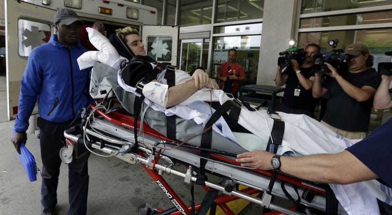 In this May 31, 2018, file photo, Ryan Straschnitzki is wheeled on a stretcher into Shriners Hospitals for Children in Philadelphia. In this May 31, 2018, file photo, Ryan Straschnitzki is wheeled on a stretcher into Shriners Hospitals for Children in Philadelphia.