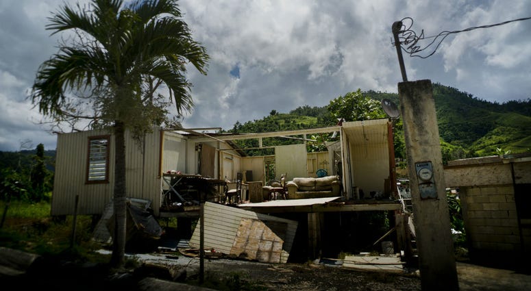 In this Sept. 8, 2018 photo, a home that was abandoned after Hurricane Maria hit one year ago stands full of furniture in the San Lorenzo neighborhood of Morovis, Puerto Rico. In this Sept. 8, 2018 photo, a home that was abandoned after Hurricane Maria hit one year ago stands full of furniture in the San Lorenzo neighborhood of Morovis, Puerto Rico.