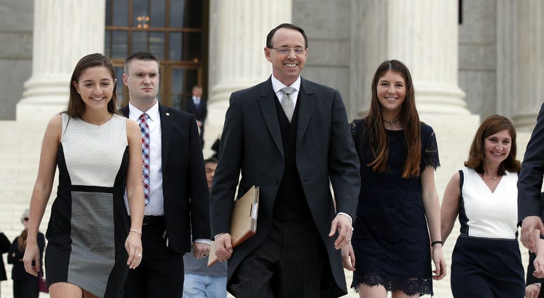 In this April 23, 2018 file photo, Deputy Attorney General Rod J. Rosenstein departs the Supreme Court in Washington, with his family, after arguing his first case before the court. In this April 23, 2018 file photo, Deputy Attorney General Rod J. Rosenstein departs the Supreme Court in Washington, with his family, after arguing his first case before the court.