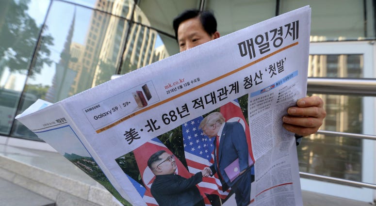 A man reads a newspaper reporting the summit between U.S. President Donald Trump and North Korean leader Kim Jong Un, at a newspaper distributing station in Seoul, South Korea, Tuesday, June 12, 2018. A man reads a newspaper reporting the summit between U.S. President Donald Trump and North Korean leader Kim Jong Un, at a newspaper distributing station in Seoul, South Korea, Tuesday, June 12, 2018.