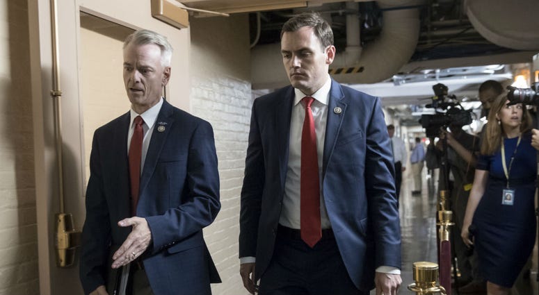 Rep. Steve Russell, R-Okla., left, and Rep. Mike Gallagher, R-Wis., walk to a closed-door meeting with House Republicans seeking more information about compromise legislation on immigration, at the Capitol in Washington, Thursday, June 21, 2018. Rep. Steve Russell, R-Okla., left, and Rep. Mike Gallagher, R-Wis., walk to a closed-door meeting with House Republicans seeking more information about compromise legislation on immigration, at the Capitol in Washington, Thursday, June 21, 2018.