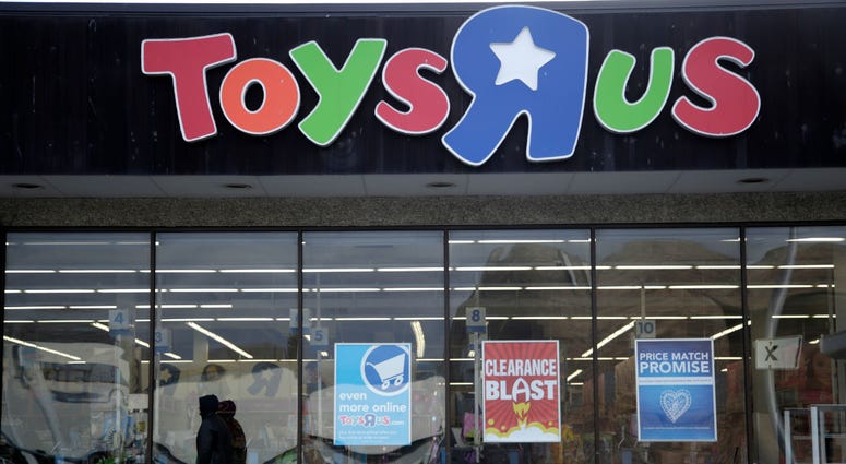 This Jan. 24, 2018, file photo shows a person walking near the entrance to a Toys R Us store, in Wayne, N.J. This Jan. 24, 2018, file photo shows a person walking near the entrance to a Toys R Us store, in Wayne, N.J.