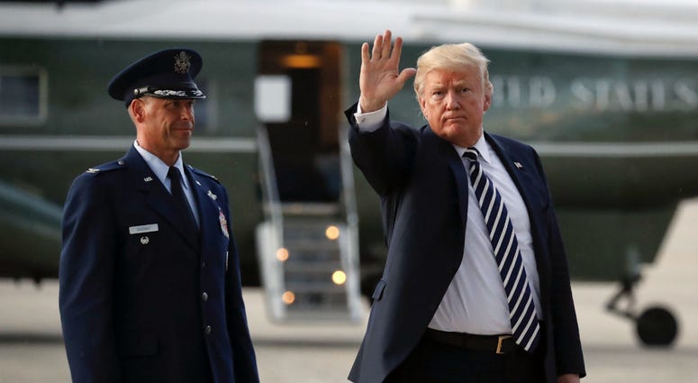 President Donald Trump waves to members of the media after arriving on Air Force One, Friday, Aug. 31, 2018 at Andrews Air Force Base in Md. Watching is Air Force Col. Samuel Chesnut. President Donald Trump waves to members of the media after arriving on Air Force One, Friday, Aug. 31, 2018 at Andrews Air Force Base in Md. Watching is Air Force Col. Samuel Chesnut.