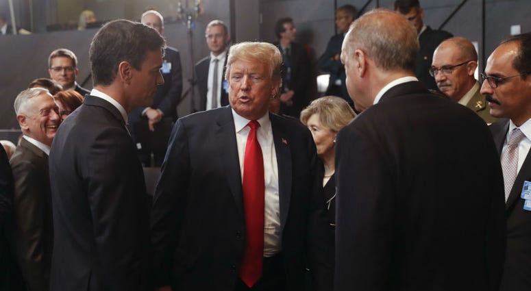 President Donald Trump, center, stops to talk with Spanish Prime Minister Pedro Sanchez, left, and Turkey's President Recep Tayyip Erdogan, right, as they attend a meeting of the North Atlantic Council. President Donald Trump, center, stops to talk with Spanish Prime Minister Pedro Sanchez, left, and Turkey's President Recep Tayyip Erdogan, right, as they attend a meeting of the North Atlantic Council.