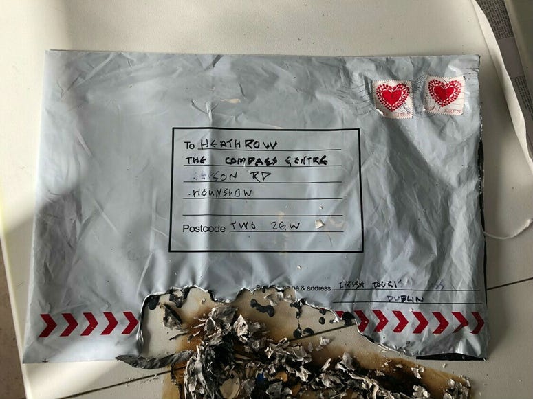 In this photo dated Tuesday March 5, 2019, issued by Britain's Metropolitan Police showing a suspect package after it ignited, sent to Heathrow airport. In this photo dated Tuesday March 5, 2019, issued by Britain's Metropolitan Police showing a suspect package after it ignited, sent to Heathrow airport.